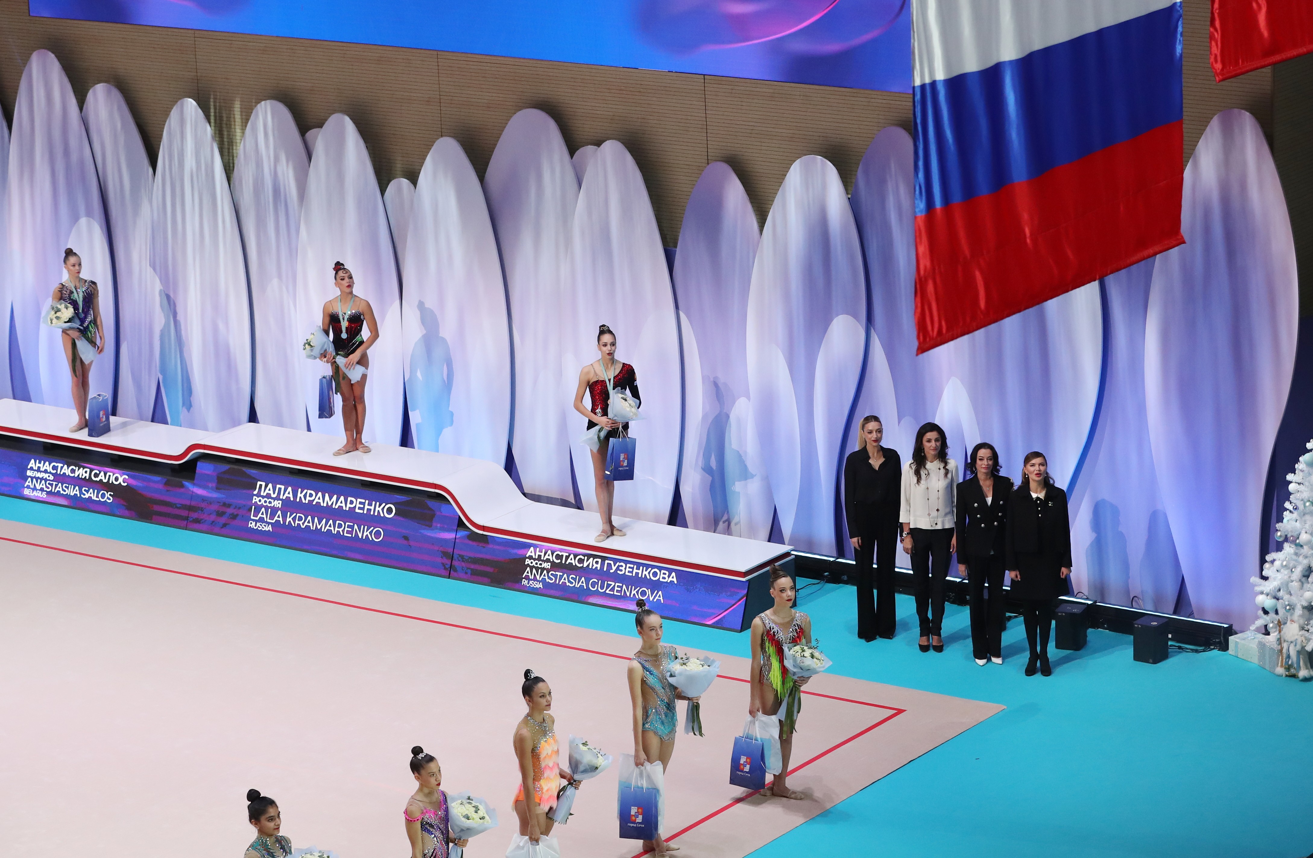 The award ceremony of the "Divine Grace" tournament. On the podium (from left to right) - Anastasia Salos, Lala Kramarenko, Anastasia Guzenkova. Next to the podium - Evgenia Kanaeva, Alexandra Timoshenko, Yulia Barsukova and Alina Kabaeva